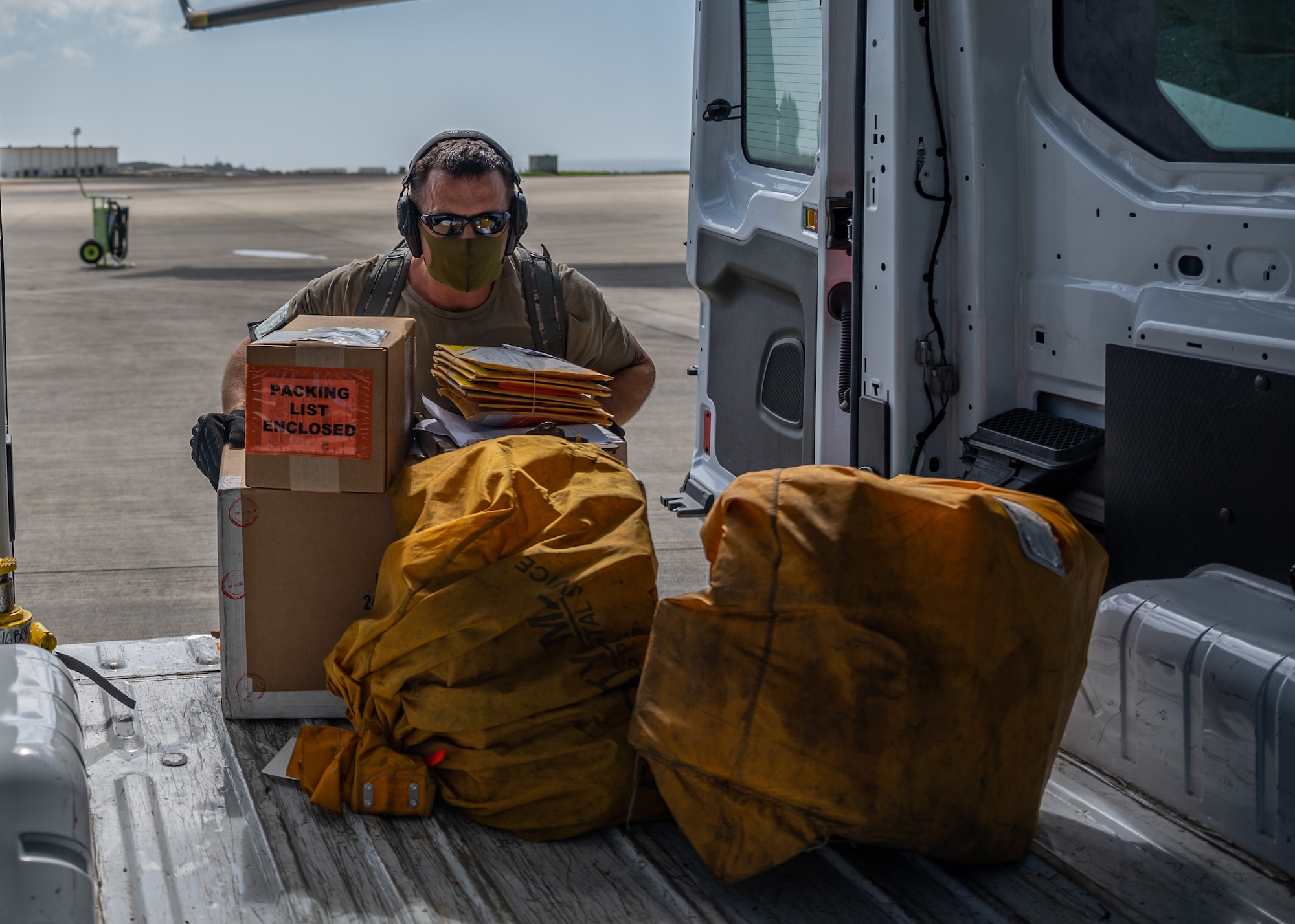 U.S. Air Force Tech. Sgt. Brandon Metz, 733rd Aircraft Maintenance Squadron aircraft services supervisor, loads packages onto a van at Kadena Air Base, Japan, Sept. 29, 2021. One of the 733rd AMS responsibilities is to ensure the proper amount of packages, passengers and anything else are aboard aircraft coming in. (U.S. Air Force photo by Airman 1st Class Stephen Pulter)