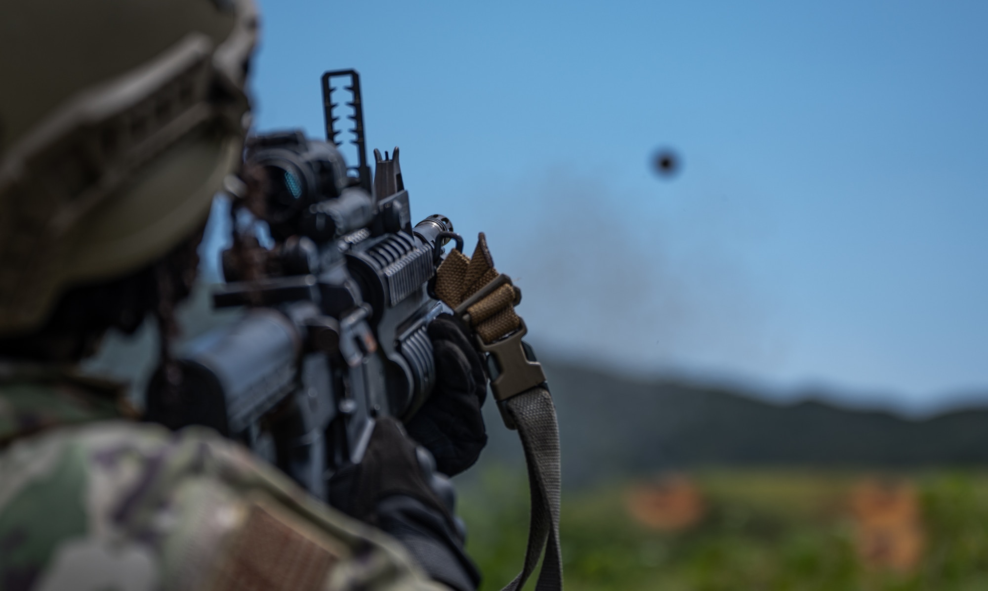 An 18th Security Forces Squadron member fires an M203 grenade launcher at Camp Hansen, Japan, Sept. 30, 2021. The M203 grenade launcher provides an extended range capability for ground troops. (U.S. Air Force photo by Airman 1st Class Stephen Pulter)
