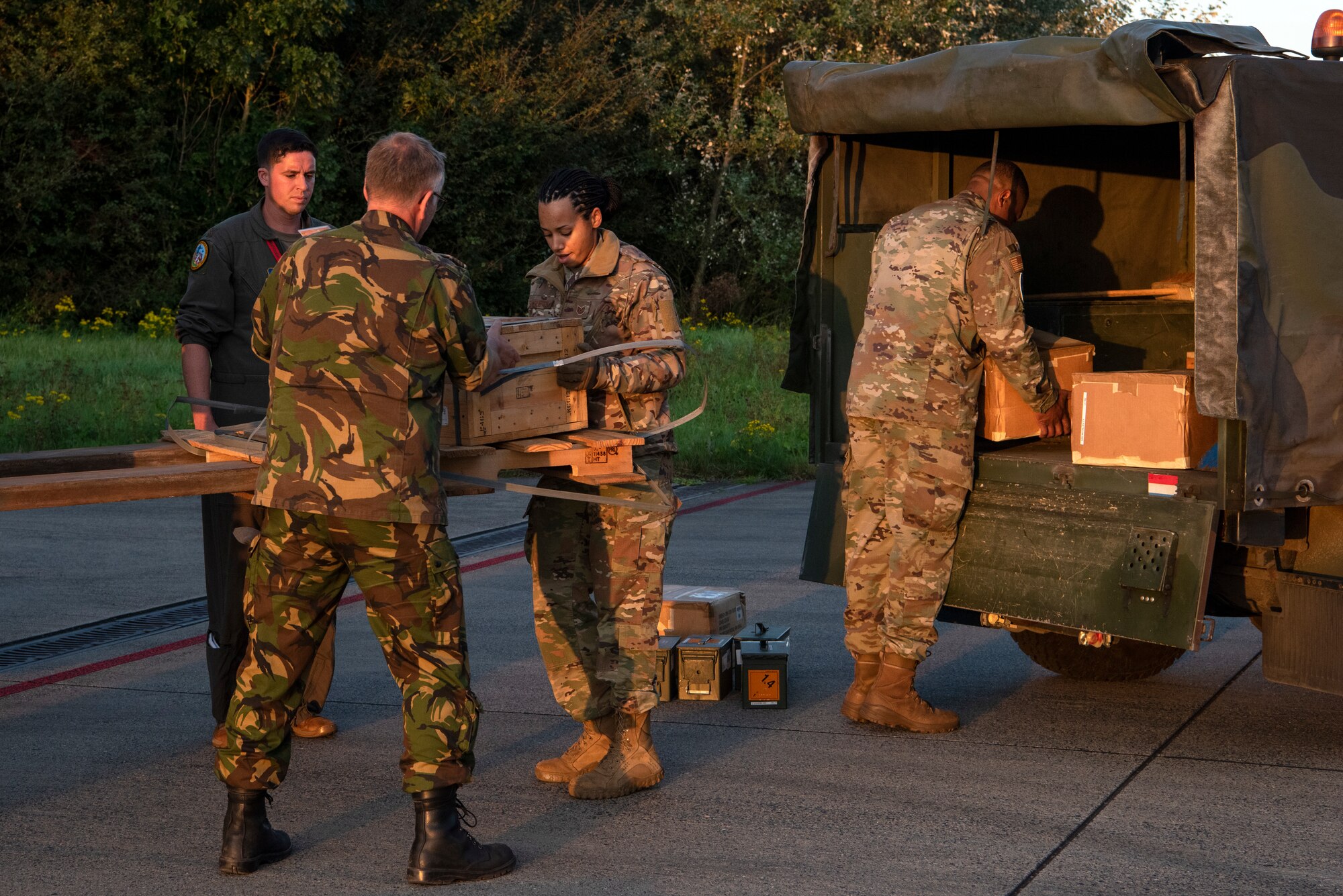U.S. Air Force Airmen and a member of the Royal Netherlands Air Force unload cargo at Leeuwarden Air Base, Netherlands, Sept. 13. 2021. The 52nd Fighter Wing with the help of the 21st Theater Sustainment Command moved 22 tons of cargo to an austere operating location during a short-notice Agile Combat Employment exercise. (U.S. Air Force photo by Tech. Sgt. Anthony Plyler)
