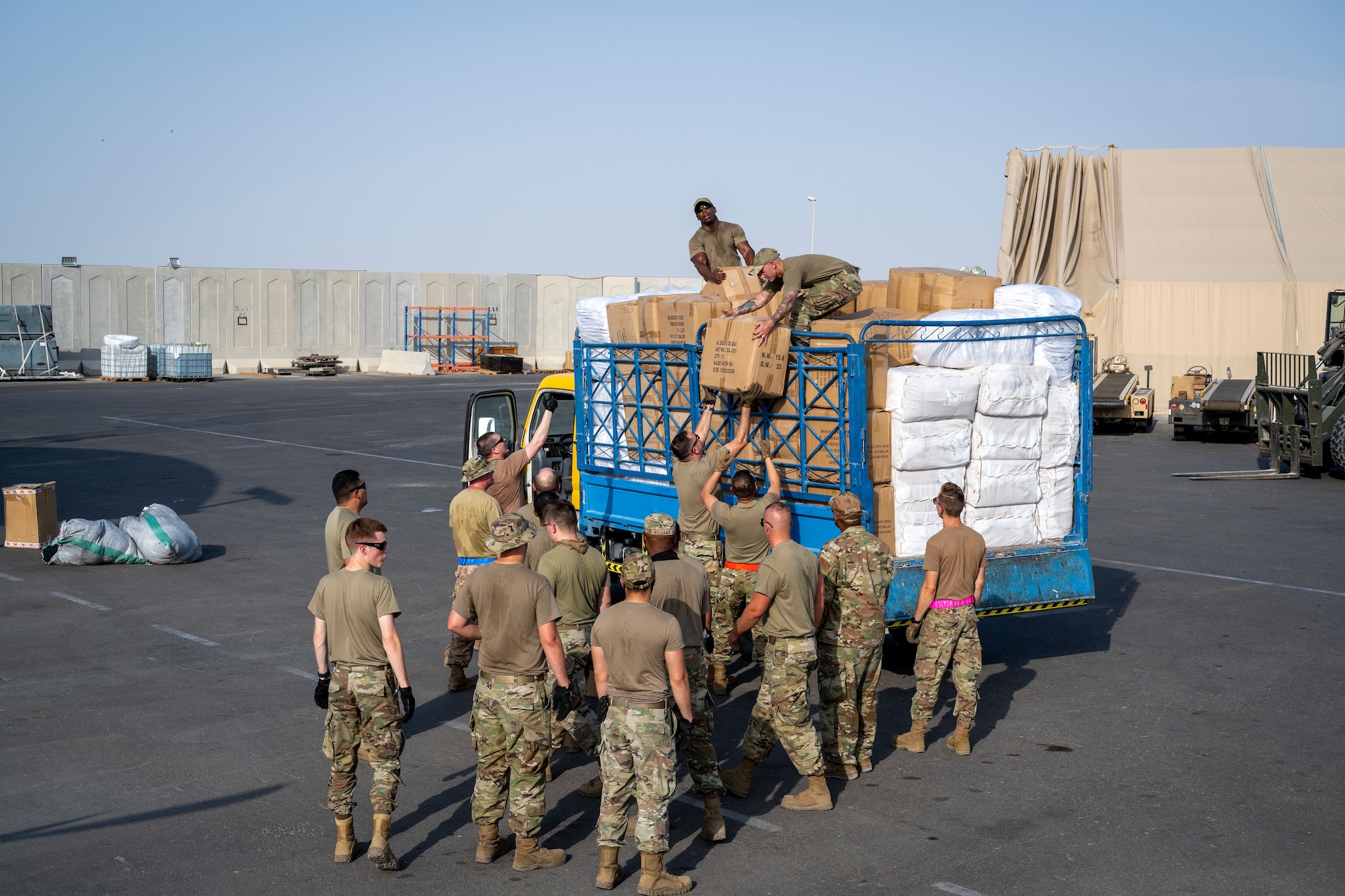 Airmen loading and packing pallets of humanitarian supplies