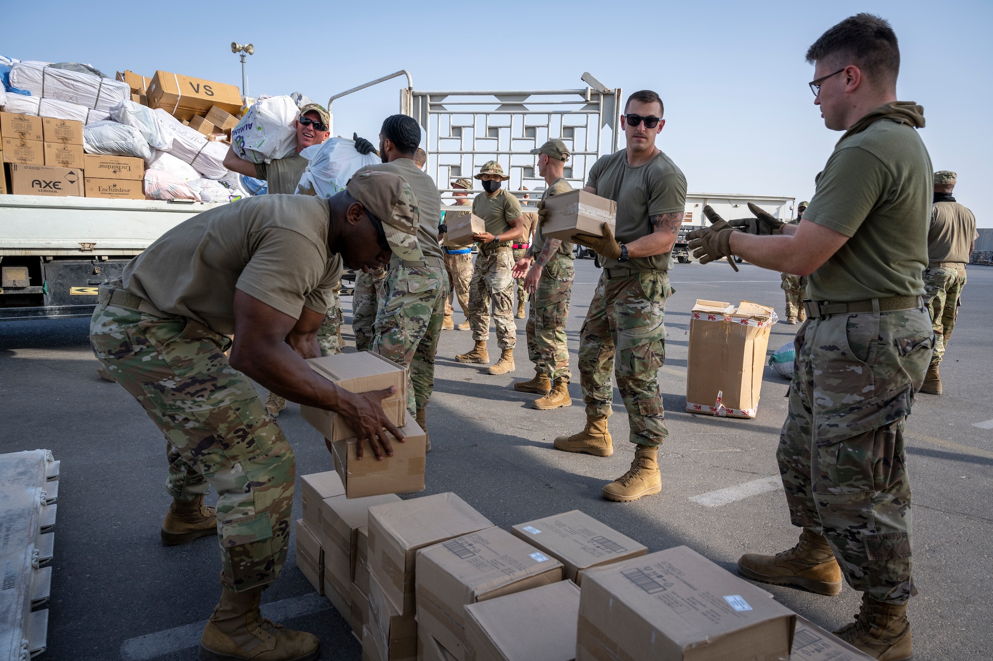 Airmen loading and packing pallets of humanitarian supplies