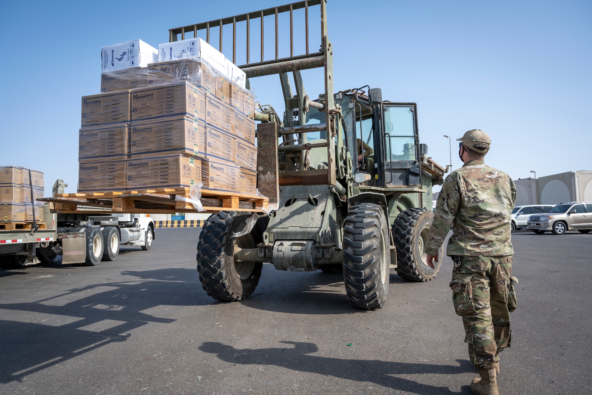 Airmen loading and packing pallets of humanitarian supplies