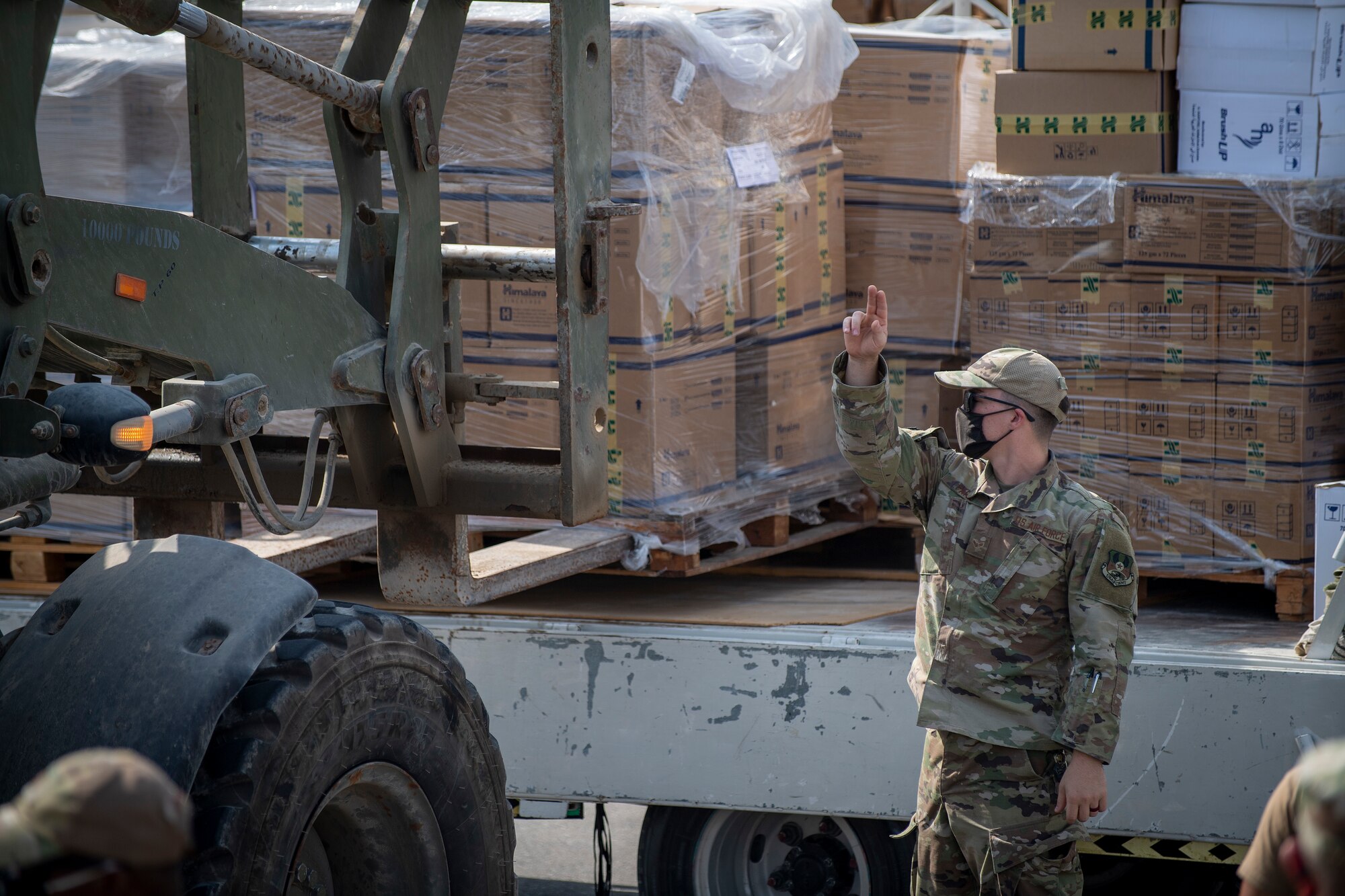 Airmen loading and packing pallets of humanitarian supplies