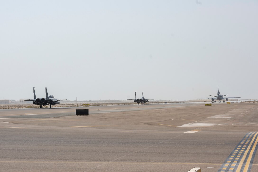 KC-10 refueling aircraft followed by two F-15 jets