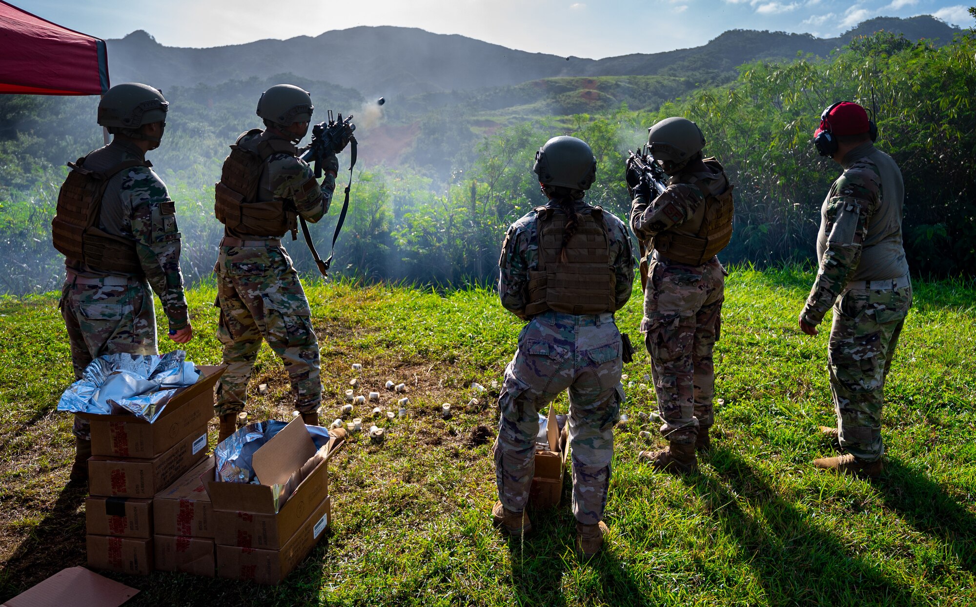 Members from the 18th Security Forces Squadron fire M203 grenade launchers at Camp Hansen, Japan, Sept. 30, 2021. The M203 grenade launcher is a rifle-mounted launcher capable of firing 40 mm rounds. (U.S. Air Force photo by Airman 1st Class Stephen Pulter)