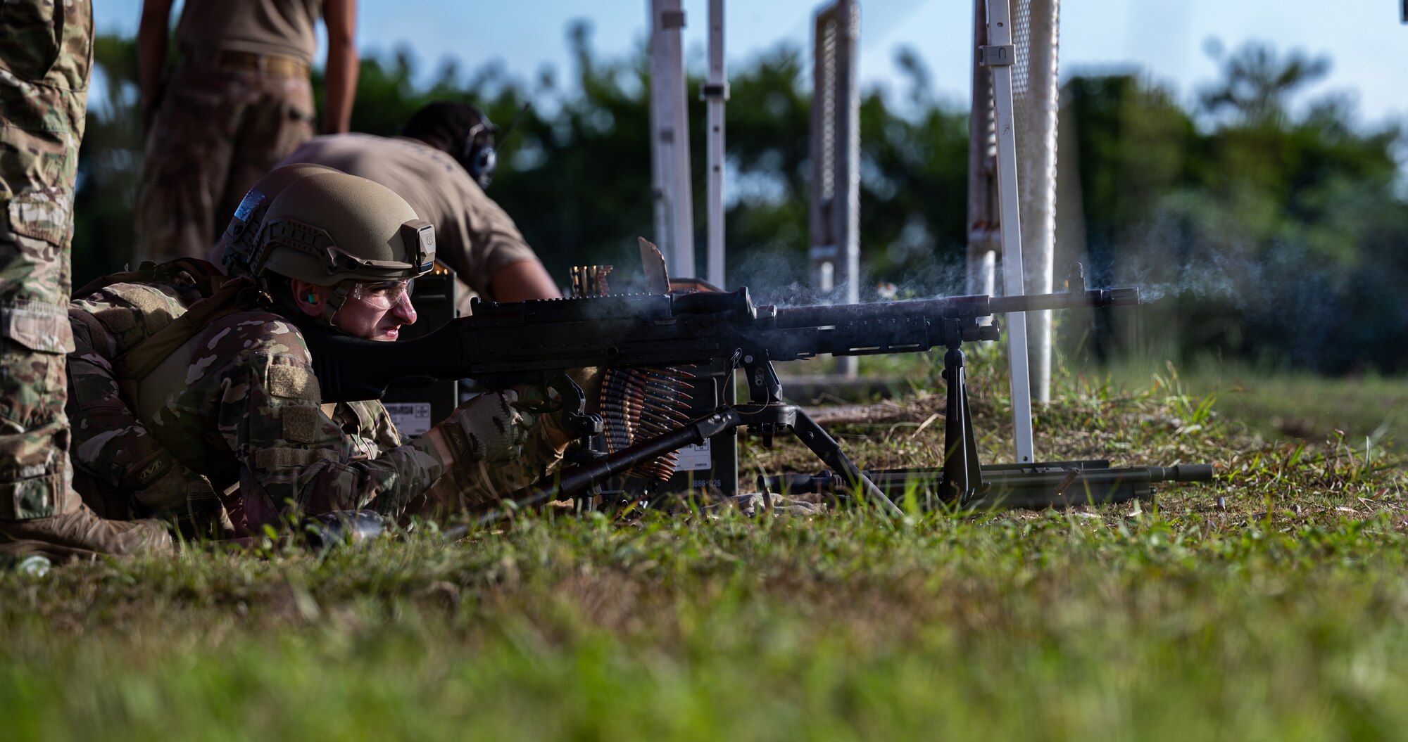 Airman 1st Class Malaka Bewar, 18th Security Forces Squadron armorer, fires an M240B machine gun at Camp Hansen, Japan, on Sept. 30, 2021. Heavy machine gun teams fire in two-man teams with the assistant gunner providing assisted stabilization, reloading and barrel changes for the primary gunner. (U.S. Air Force photo by Airman 1st Class Stephen Pulter)