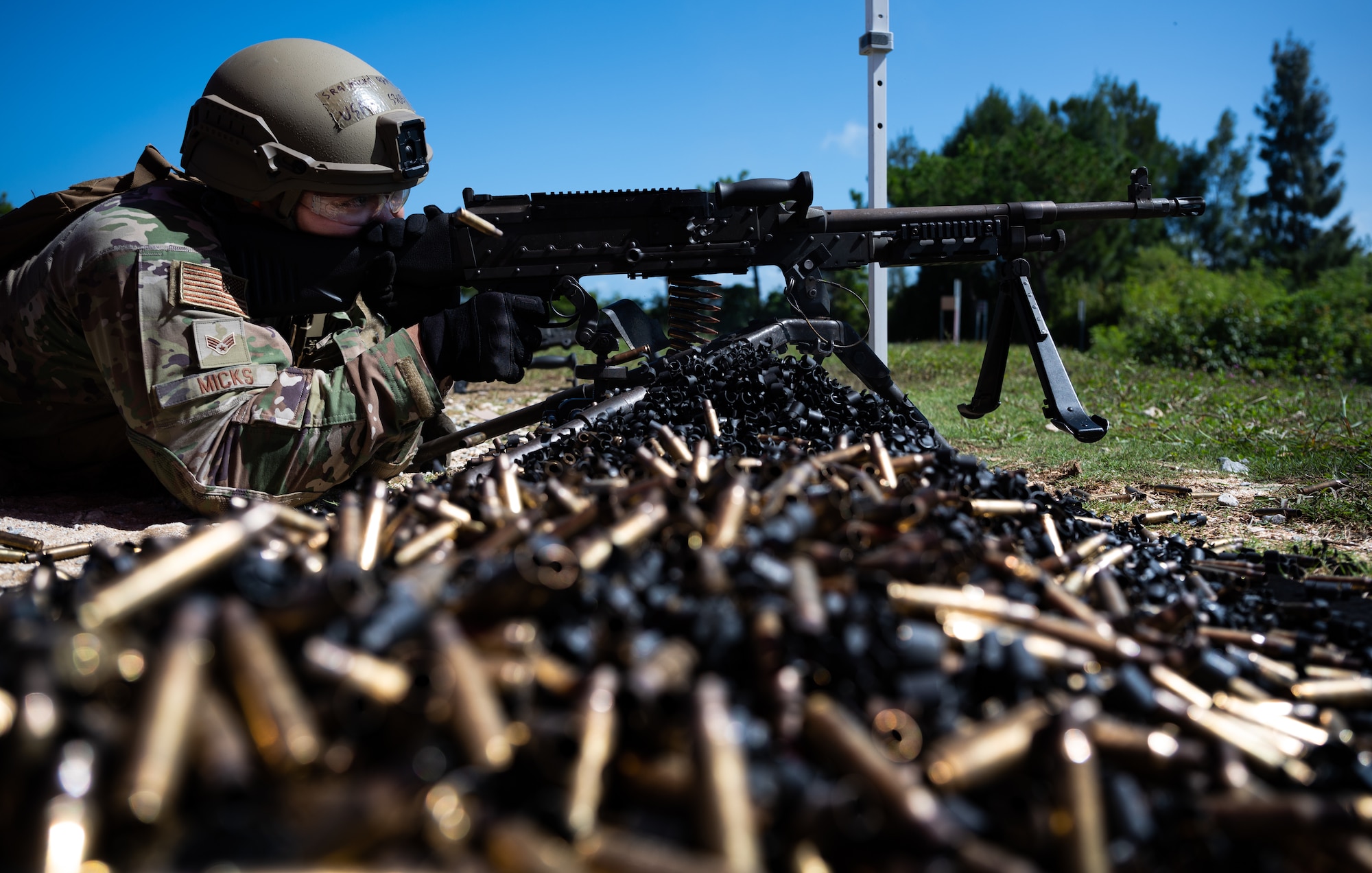 Senior Airman Gabriel Micks, 18th Security Forces Squadron member, fires an M240B at Camp Hansen, Japan, Sept. 30, 2021. The 18th SFS provides aircraft security and maintains the largest security force mobility commitment in the Pacific Air Forces. (U.S. Air Force photo by Airman 1st Class Stephen Pulter)