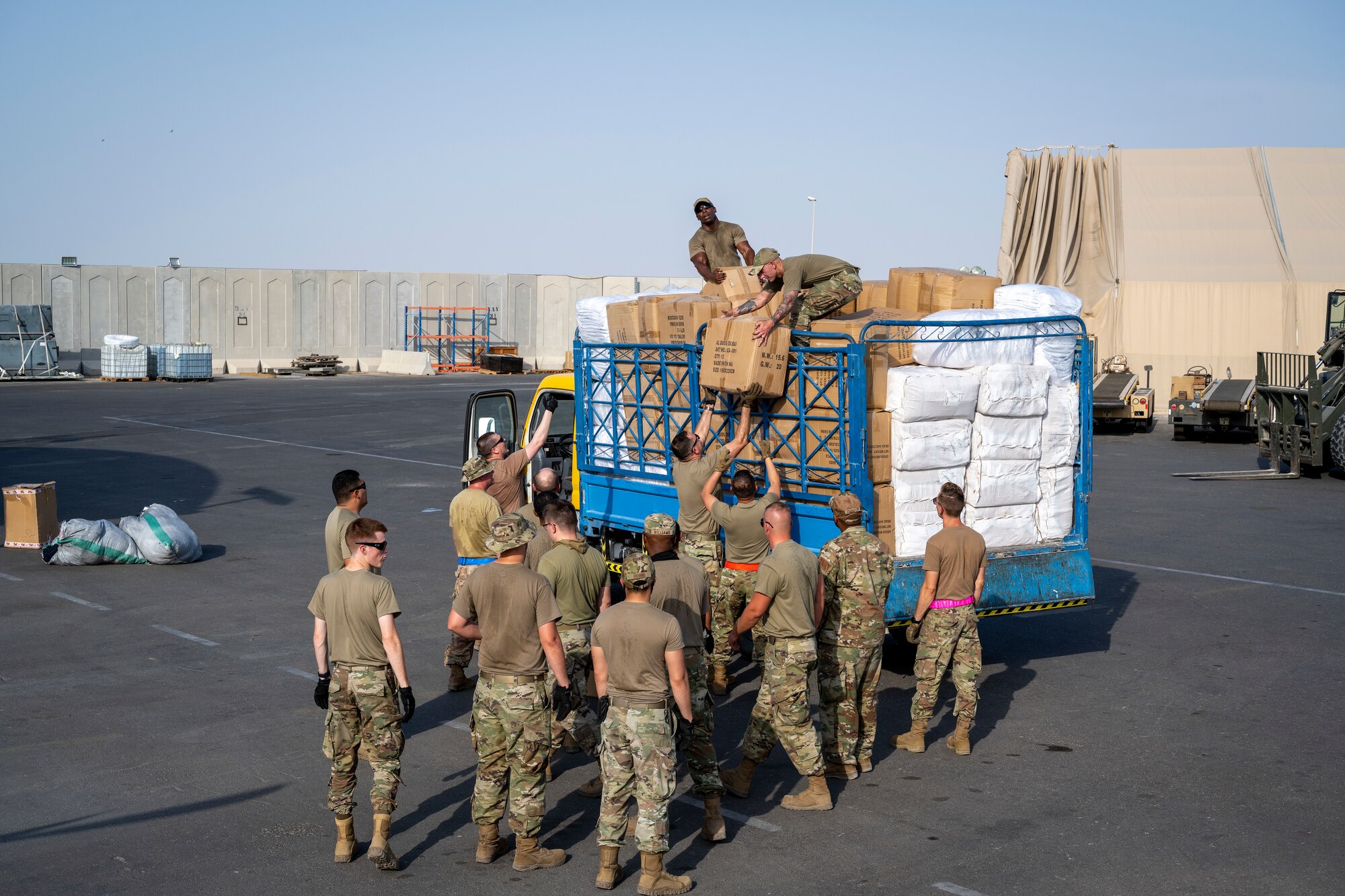 Airmen loading and packing pallets of humanitarian supplies