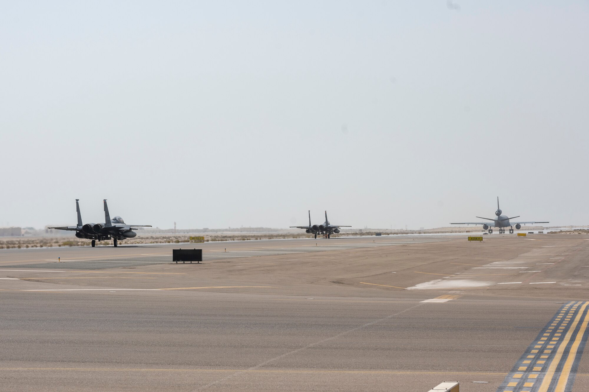 KC-10 refueling aircraft followed by two F-15 jets