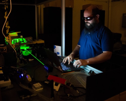 Steve Zuraski, an optical engineer with the Air Force Research Laboratory, works with a laser in an Air Force Institute of Technology lab at Wright-Patterson Air Force Base, Ohio, June 21, 2017. Zuraski is an AFIT student earning an advanced degree in engineering physics. (U.S. Air Force photo by R.J. Oriez)