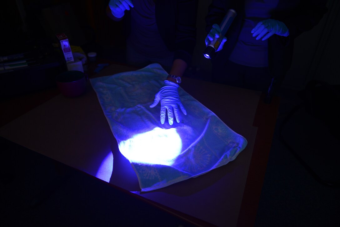 Air Force Office of Special Investigation 13th Field Investigations Squadron agents demonstrate a DNA sample search on a towel Aug. 11, 2016, at Ramstein Air Base, Germany. There are three fields of operations at the AFOSI: criminal investigation, fraud investigation and counter-intelligence investigation. (U.S. Air Force photo/ Airman 1st Class Joshua Magbanua)