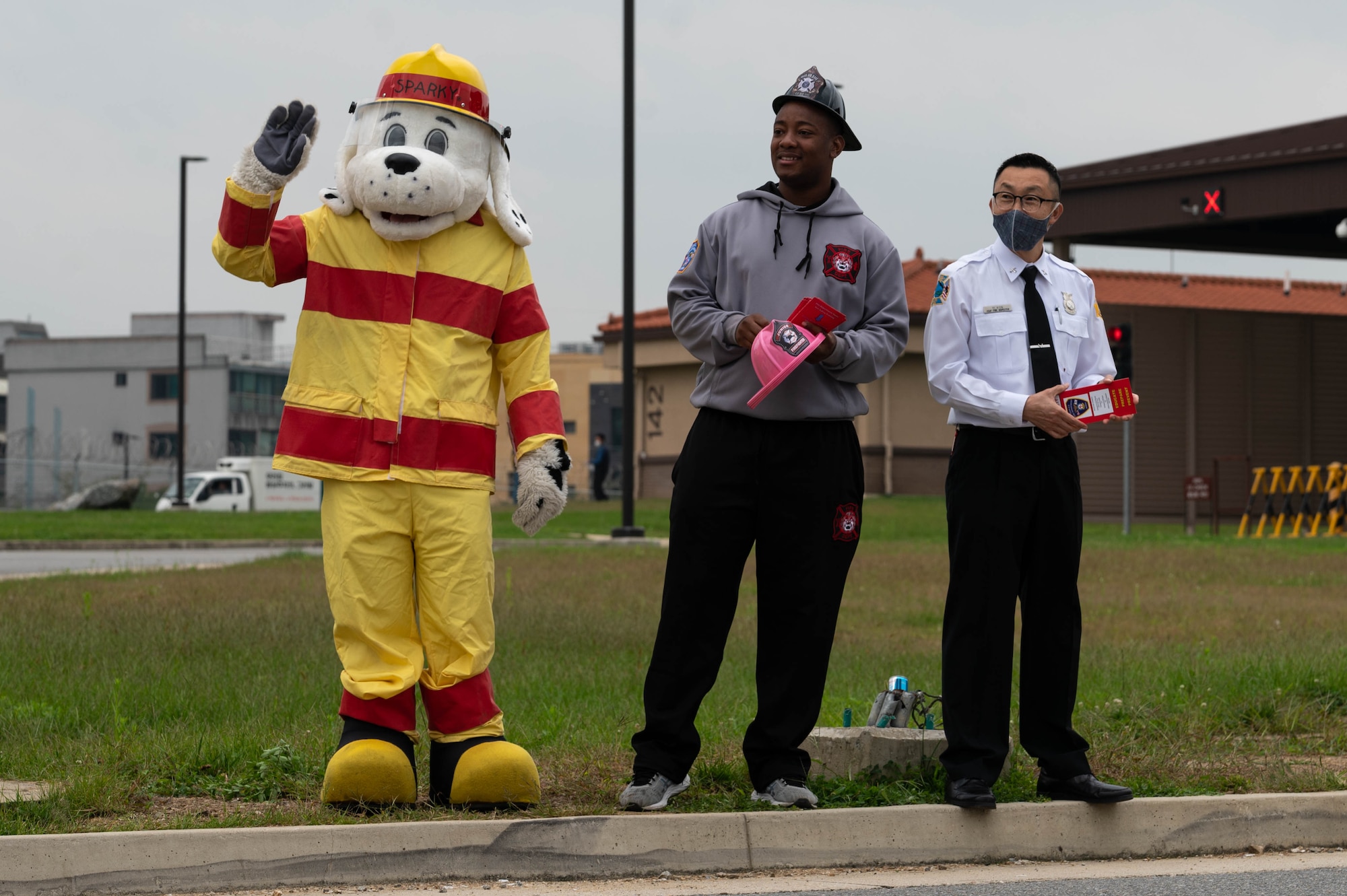The 51st Fighter Wing Fire Department brings awareness to Fire Prevention week by passing out brochures outside the Morin Gate