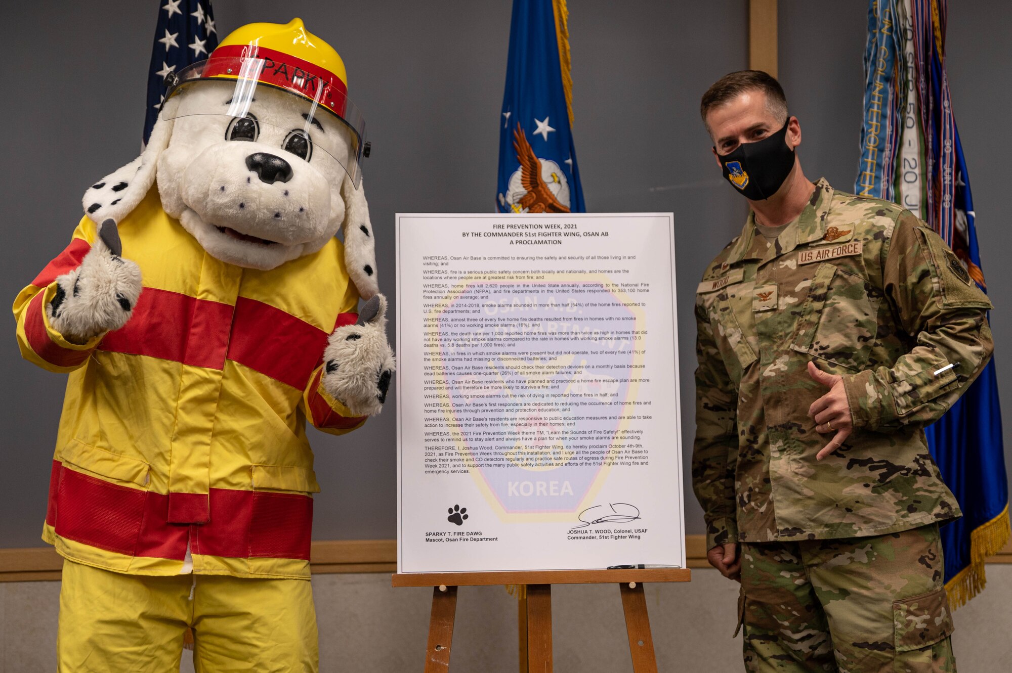 Col. Joshua Wood, 51st Fighter Wing commander, signs the Fire Prevention Week proclamation