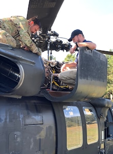 Don Camp, a U.S. Army Aviation and Missile Command Logistics Assistance Representative assigned to the 405th Army Field Support Brigade’s Army Field Support Battalion Germany, provides technical training to a Soldier with C Company's MEDEVAC flight crew, 2nd General Support Aviation Battalion, 1st Combat Aviation Brigade, while supporting Saber Junction 21 at Hohenfels Training Area, Germany, Sept. 23.