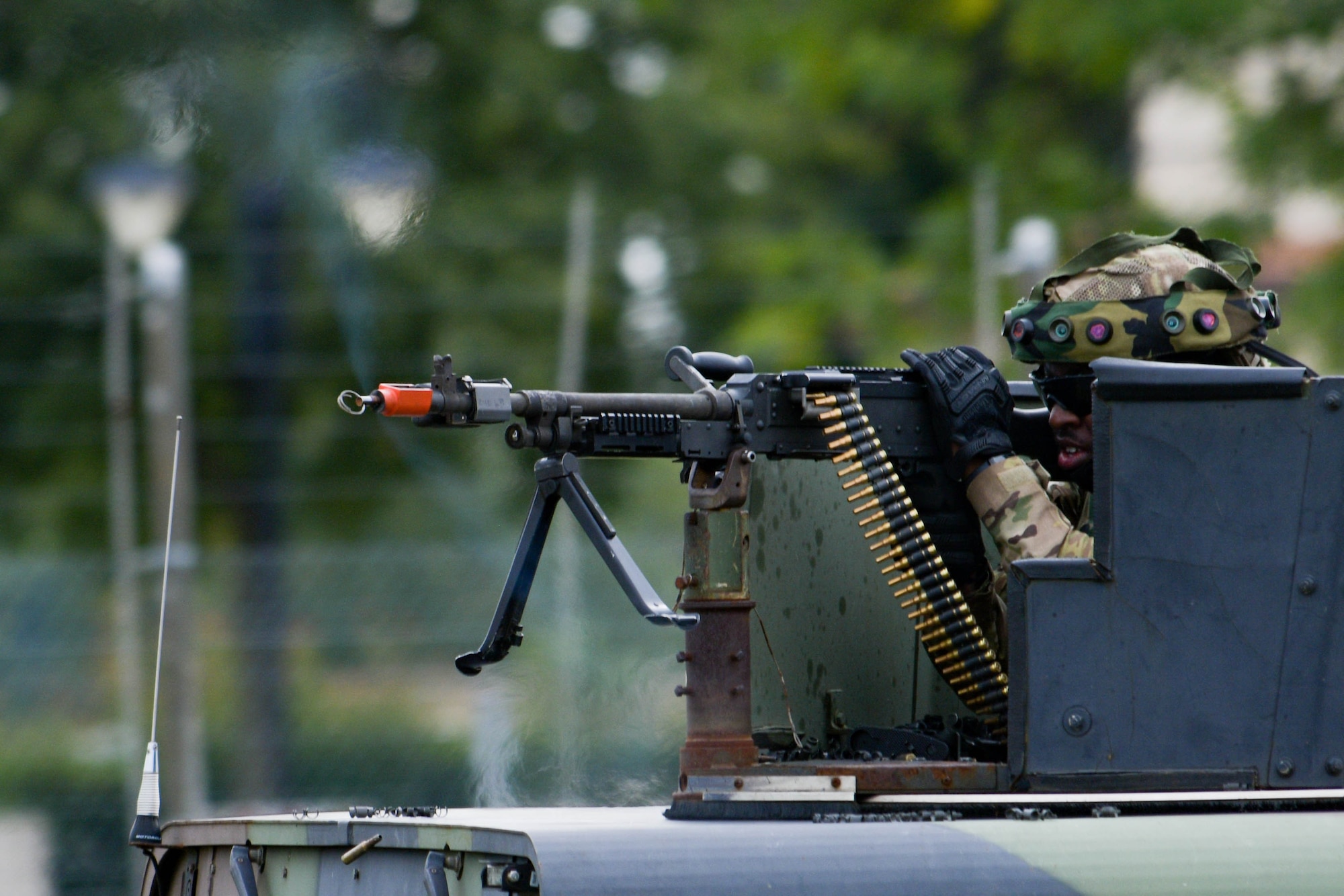 An Airman assigned to the 31st Security Forces Squadron shoots an M240 machine gun during exercise Steadfast Nomad (STND) 2021 at Aviano Air Base, Italy, Sept. 22, 2021. During the exercise, the 31st SFS trained to tactically respond to threats on Aviano and practiced responding with more personnel, weapons, and armored HHMWVs. (U.S. Air Force photo by Senior Airman Brooke Moeder)
