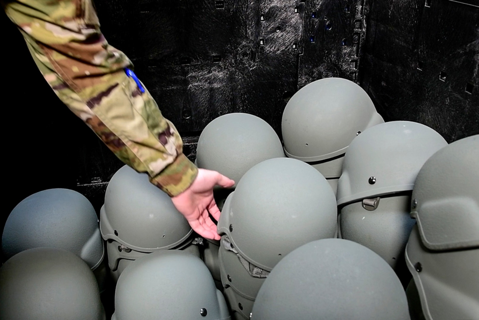 U.S. Air Force Staff Sgt. Christopher Thompson, 163d Logistics Readiness Squadron material management specialist, grabs a helmet for a service member during a deployment training exercise at March Air Reserve Base, California, Oct. 2, 2021. The training exercise, dubbed Grizzly Lightning, is phase one of a three-phase process.