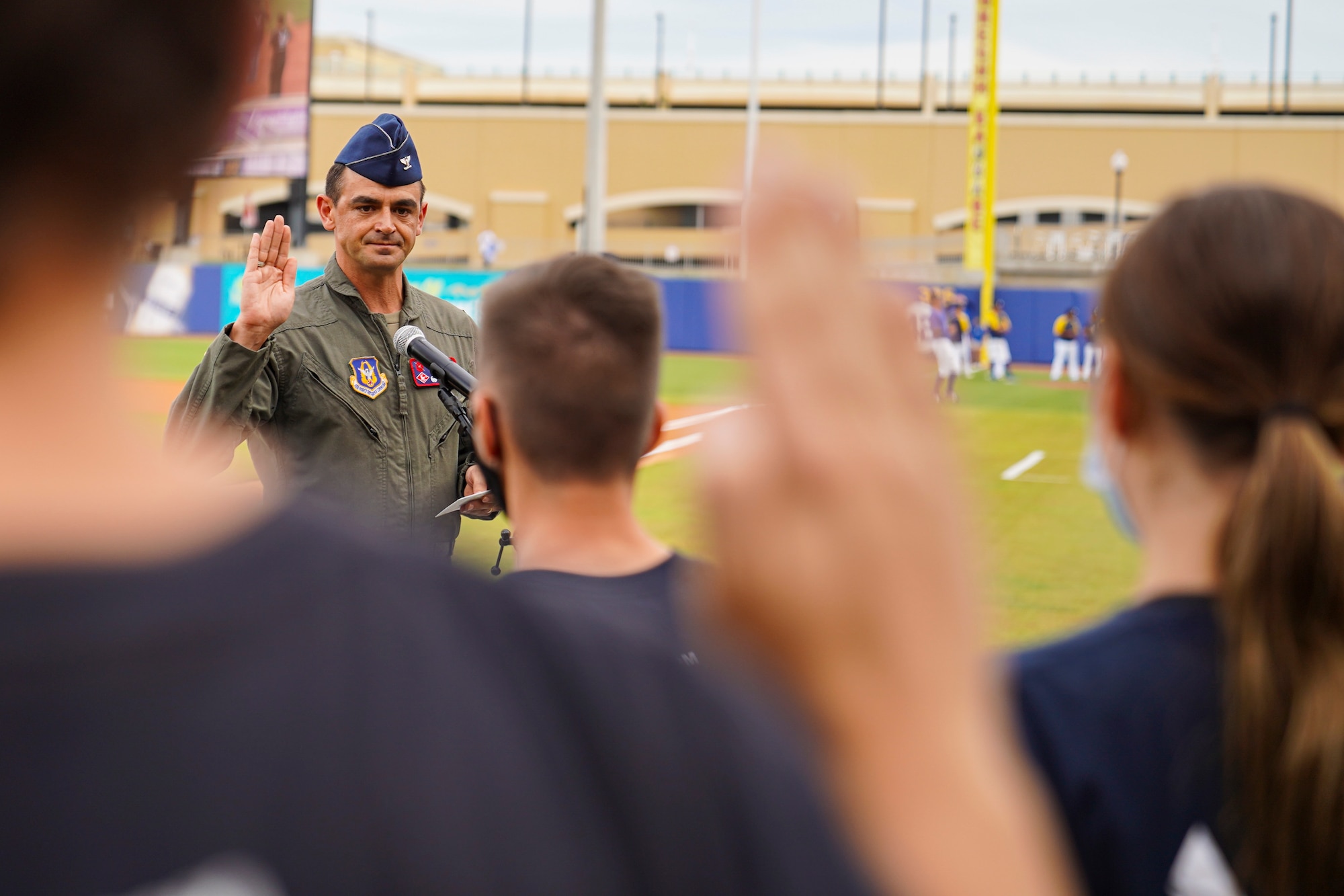U.S. Air Force Col. Stuart Rubio, 403rd Wing commander, recites the oath of enlistment to Air Force delayed entry program recruits during the Biloxi Shuckers Minor League Baseball game in Biloxi, Mississippi, September 18, 2021. The military appreciation night consisted of two games back to back where Rubio threw the first pitch during pre-game festivities, technical training students displayed the U.S. flag and the Keesler Honor Guard presented colors. (U.S. Air Force photo by Senior Airman Spencer Tobler)