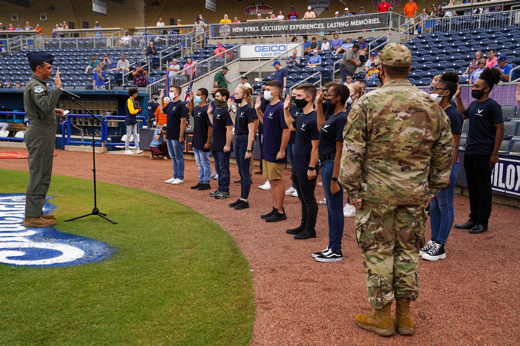 U.S. Air Force Col. Stuart Rubio, 403rd Wing commander, recites the oath of enlistment to Air Force delayed entry program recruits during the Biloxi Shuckers Minor League Baseball game in Biloxi, Mississippi, September 18, 2021. The military appreciation night consisted of two games back to back where Rubio threw the first pitch during pre-game festivities, technical training students displayed the U.S. flag and the Keesler Honor Guard presented colors. (U.S. Air Force photo by Senior Airman Spencer Tobler)
