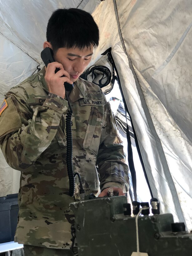 U.S. Army Reserve Staff Sgt. Hyungeeu Choi, S-6 for the 12th Psychological Operations Battalion, sets up a radio in the 12th POB Tactical Operations Center (TOC). Soldiers from the 361st Tactical Psychological Operations Company, based in Bothell, Wash., and the 12th Psychological Operations Battalion, headquartered in Mountain View, Calif., conducted tactical psychological operations and collective training Aug. 14 – 23, 2021, Joint Base Lewis McChord, Wash. The exercise is part of the unit’s annual training, focusing on preparing the unit to operate in a multi-domain, hybrid-threat environment.