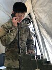 U.S. Army Reserve Staff Sgt. Hyungeeu Choi, S-6 for the 12th Psychological Operations Battalion, sets up a radio in the 12th POB Tactical Operations Center (TOC). Soldiers from the 361st Tactical Psychological Operations Company, based in Bothell, Wash., and the 12th Psychological Operations Battalion, headquartered in Mountain View, Calif., conducted tactical psychological operations and collective training Aug. 14 – 23, 2021, Joint Base Lewis McChord, Wash. The exercise is part of the unit’s annual training, focusing on preparing the unit to operate in a multi-domain, hybrid-threat environment.