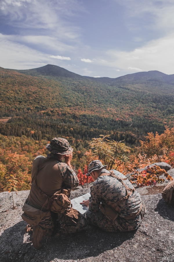 U.S. Marine Corps Lance Cpl. Eugenio Martin, left, and Cpl. Gabriel Chesser, both reconnaissance Marines with Bravo Company, 2d Reconnaissance Battalion, 2d Marine Division, finds their position using terrain during a training exercise in northern Maine on Sept. 20, 2021.