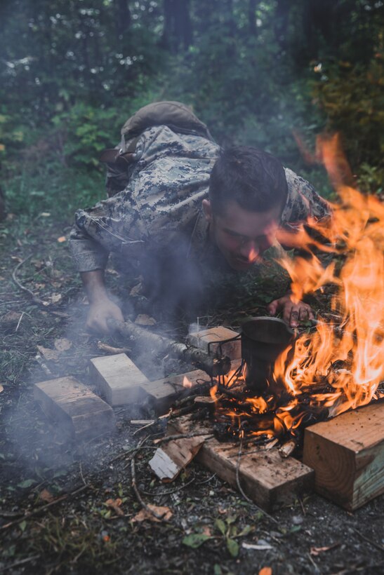 U.S. Marine Corps Cpl. Franceso Prestia, an assistant team leader with Bravo Company, 2d Reconnaissance Battalion, 2d Marine Division, starts a fire during a training exercise in northern Maine on Sept. 20, 2021. The training was designed to improve survival skills in a diverse environment. (U.S. Marine Corps photo by Cpl. Elijah J. Abernathy)