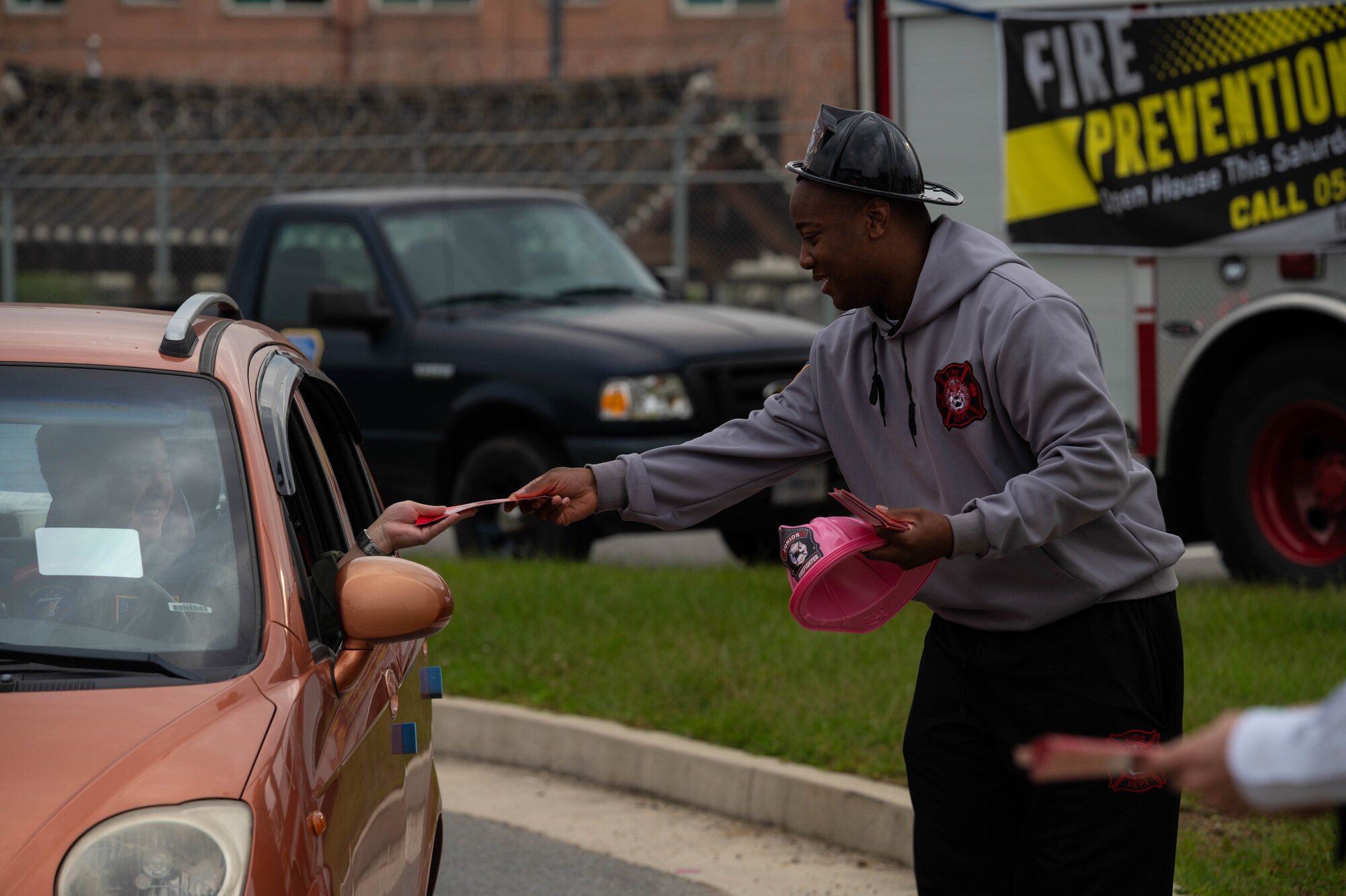 Tech. Sgt. Corey Barret, 51st Civil Engineer Squadron firefighter, hands out fire safety brochures at the Morin Gate at Osan Air Base