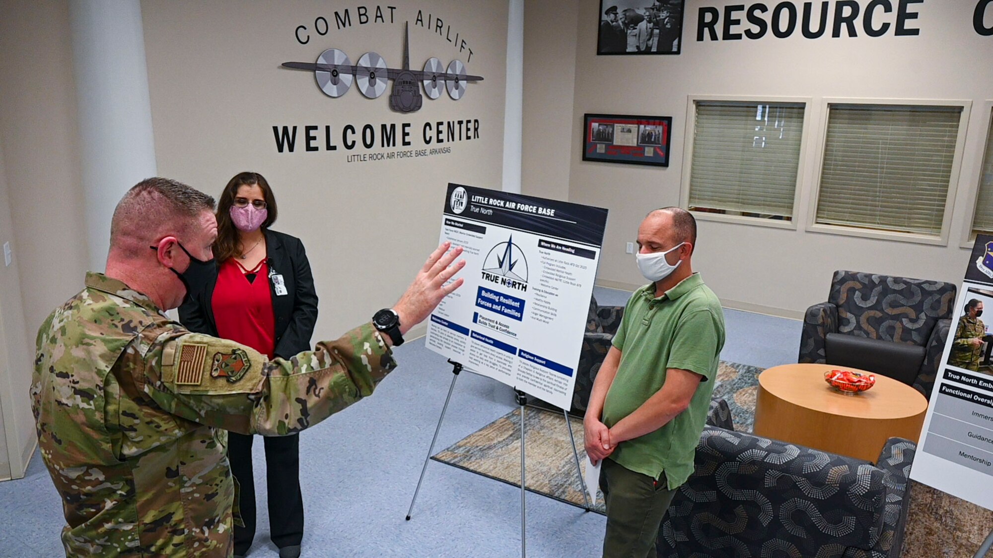 A man is briefed by two people