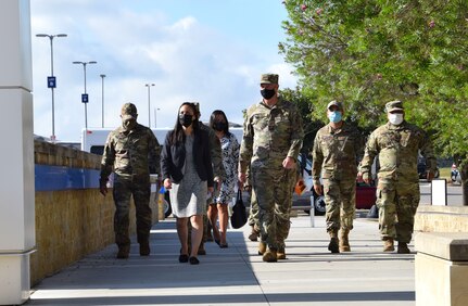 Under Secretary of the Air Force Gina Ortiz Jones walks with Col. Terry McClain, 433rd Airlift Wing commander, to view the mandatory COVID-19 vaccination process at Joint Base San Antonio-Lackland, Texas, Oct. 2, 2021. (U.S. Air Force photo by Tech. Sgt. Samantha Mathison)