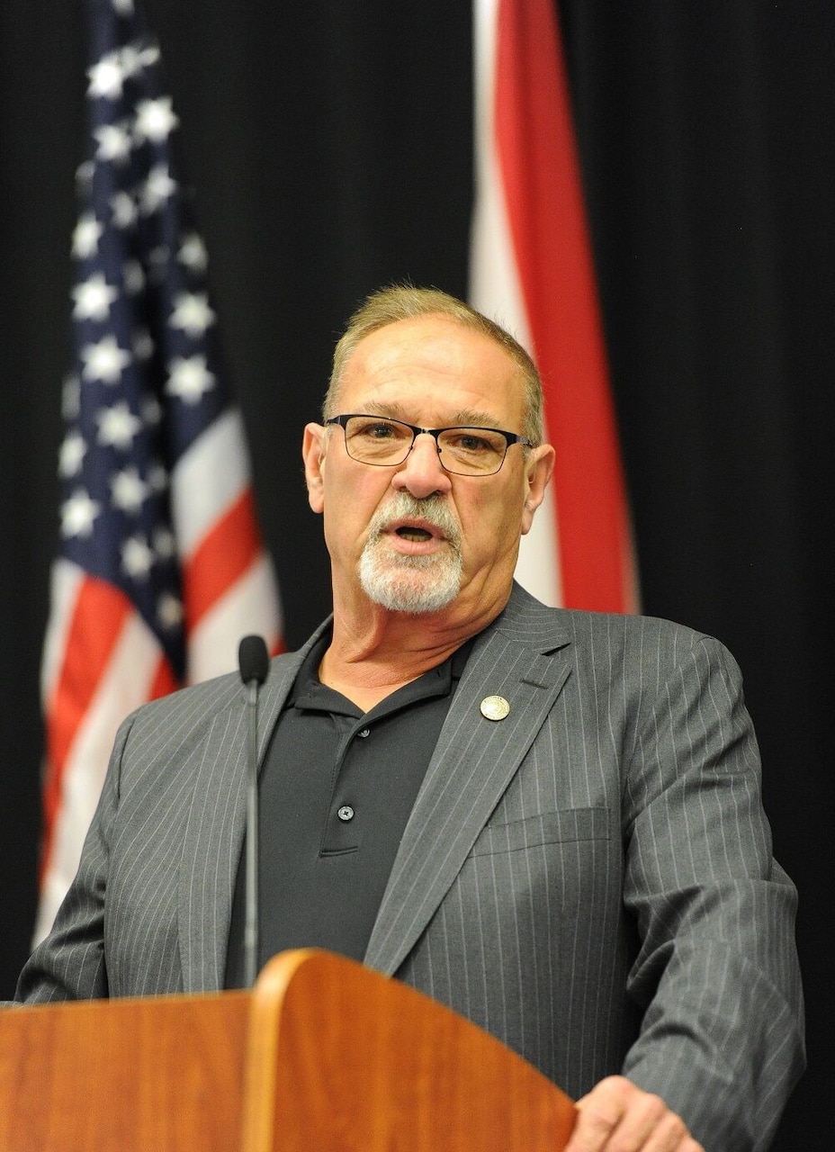 A man speaks into a microphone.