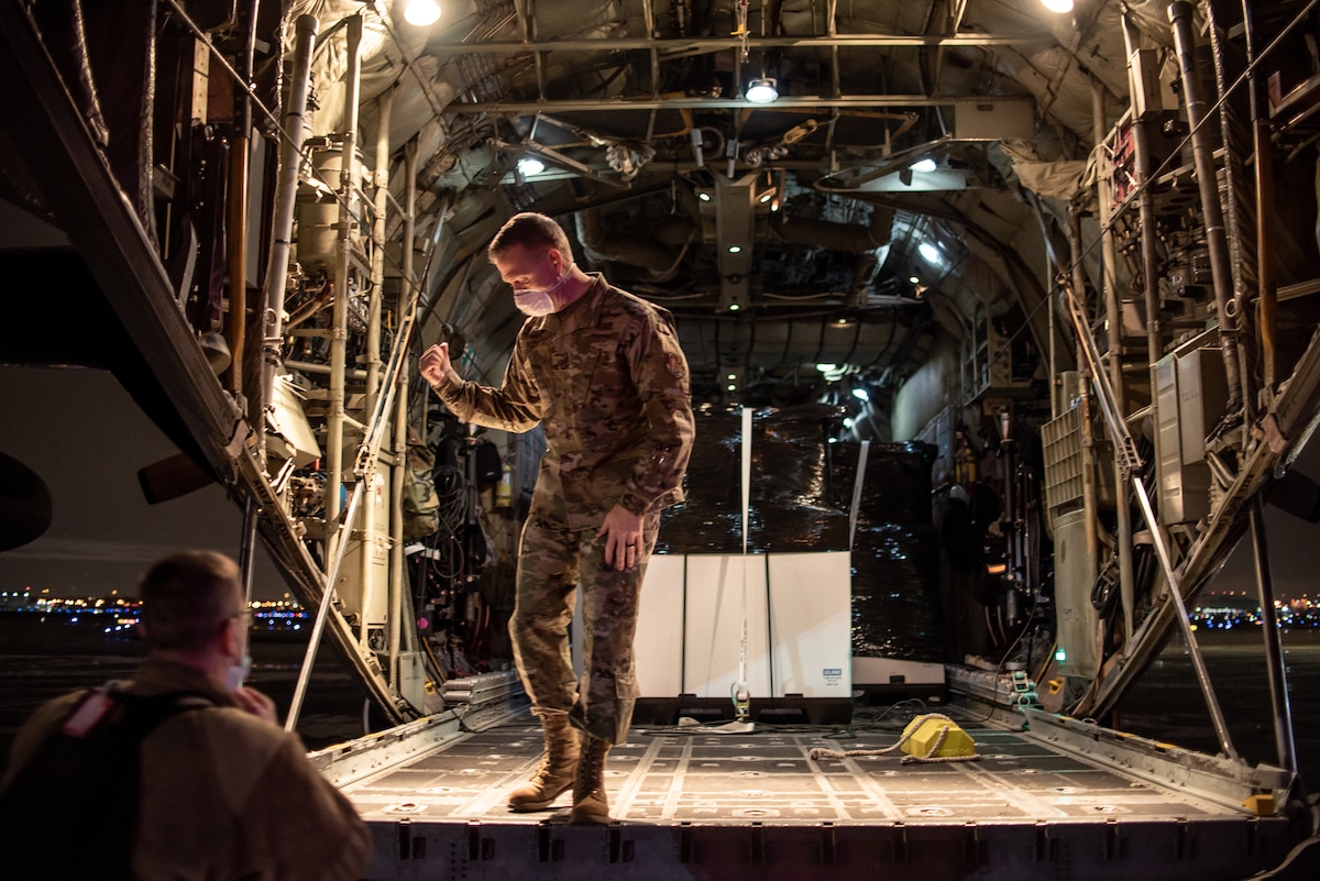 An Airman assigned to the 182nd Airlift Wing, Illinois Air National Guard, delivers 250 medical isolation pods to Chicago Midway International Airport, Chicago, Ill., April 8, 2020. Two 182nd Airlift Wing C-130 aircraft and aircrews flew the pods cross-country and overnight in a homeland defense mission for use at the McCormick Place COVID-19 alternate care facility. (U.S. Air Force Photo by Senior Airman Jay Grabiec)