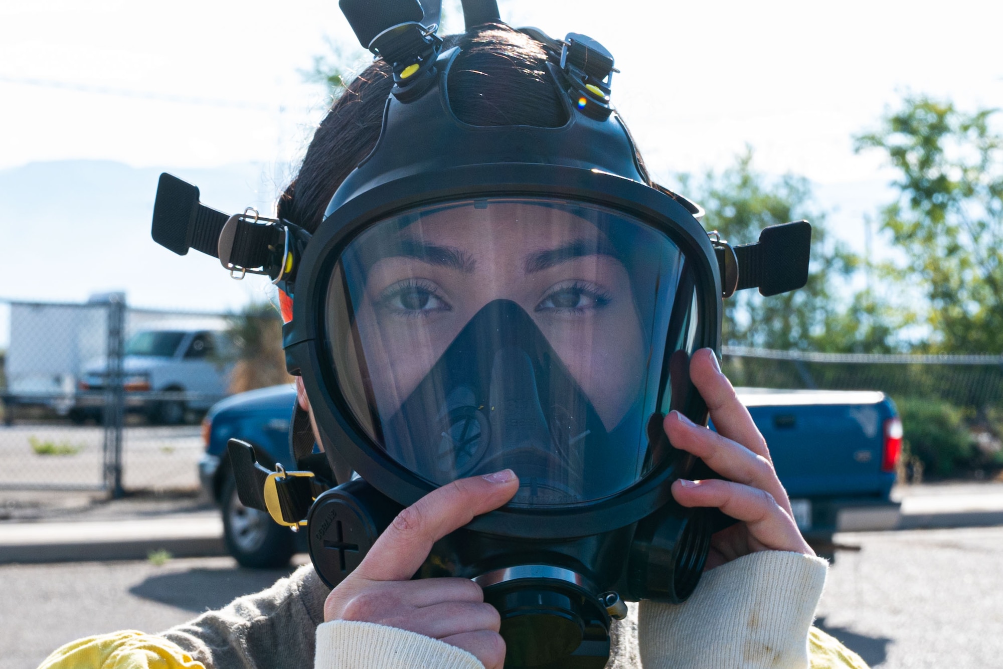 Airman 1st Class Erika Vega, 49th Civil Engineer Squadron emergency management apprentice, dons a 3M 7800B mask during a radiological survey exercise Oct. 1, 2021 on Holloman Air Force Base, New Mexico. As part of the exercise, participants practiced the proper wear and use of personal protection equipment to prepare for a possible real-world contamination scenario. (U.S. Air Force photo by Tech. Sgt. BreeAnn Sachs)