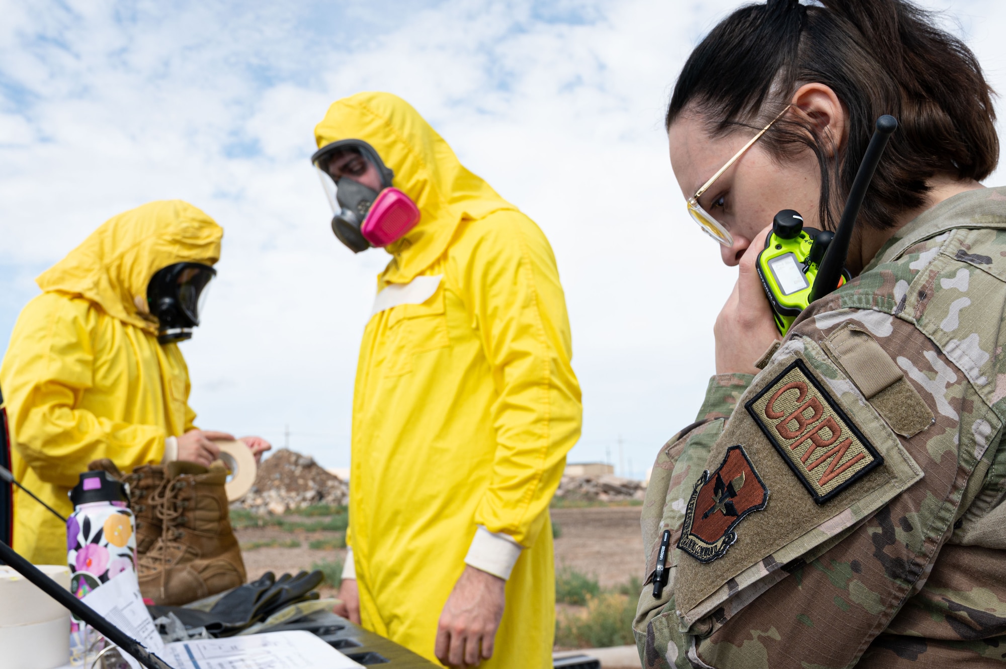 Airman 1st Class Kamryn Khalaj, 49th Civil Engineer Squadron emergency management journeyman, makes a radio call during a radiological survey exercise Oct. 1, 2021 on Holloman Air Force Base, New Mexico. During the exercise, the junior Airmen were preforming the leadership roles of command and control, incident commander and team leads to prepare for future leadership responsibilities. (U.S. Air Force photo by Tech. Sgt. BreeAnn Sachs)