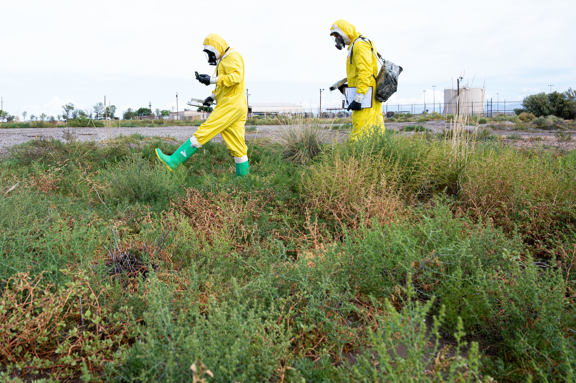 (From left to right) Airman 1st Class Shayne Watts, 49th Civil Engineer Squadron emergency management journeyman and Staff Sgt. Christopher Greeno, 49th CES emergency management craftsman, search for a possible radiation source during a radiological survey exercise Oct. 1, 2021 on Holloman Air Force Base, New Mexico. Watts surveyed for beta and gamma radiation as the front survey team member, and Greeno surveyed for alpha radiation. (U.S. Air Force photo by Tech. Sgt. BreeAnn Sachs)