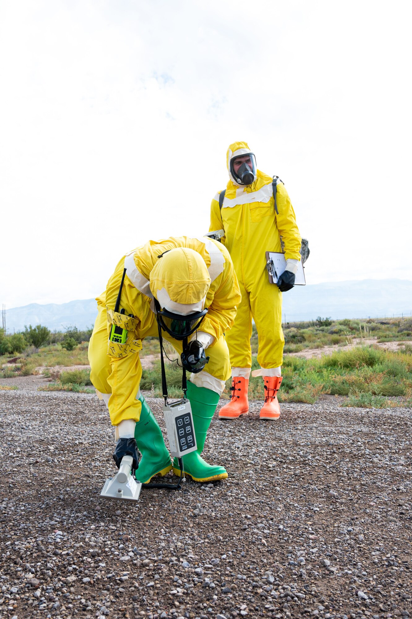 (From left to right) Airman 1st Class Shayne Watts, 49th Civil Engineer Squadron emergency management journeyman, uses an ADM-300 survey meter to detect possible beta and gamma radiation while simulating being part of a survey team with Staff Sgt. Christopher Greeno, 49th CES emergency management craftsman, during a radiological survey exercise Oct. 1, 2021 on Holloman Air Force Base, New Mexico. The person leading the survey team detects for possible beta and gamma radiation while the person behind detects for possible alpha radiation. (U.S. Air Force photo by Tech. Sgt. BreeAnn Sachs)