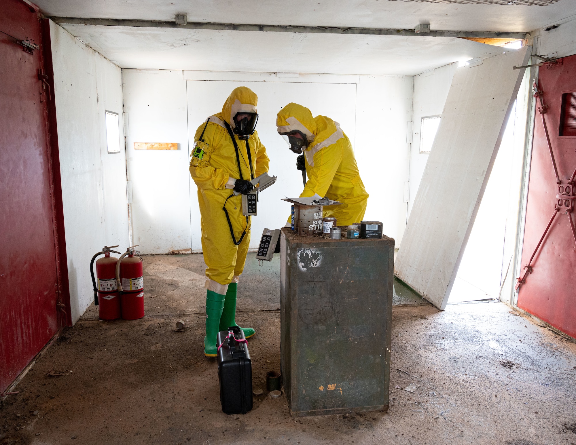 (From left to right) Airman 1st Class Shayne Watts, 49th Civil Engineer Squadron emergency management journeyman and Staff Sgt. Christopher Greeno, 49th CES emergency management craftsman, identify the radiation source during a radiological survey exercise Oct. 1, 2021 on Holloman Air Force Base, New Mexico. The radiation source was hidden before the exercise began, and survey teams had to find the source’s location by using ADM-300 radiation survey meters. (U.S. Air Force photo by Tech. Sgt. BreeAnn Sachs)