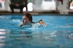 Staff Sgt. Sara Kolinski, 104th Fighter Wing public affairs specialist, swims during the German Armed Forces Proficiency Badge event Sept. 9, 2021, at Hanscom Air Force Base, Massachusetts. Participants were tested over a three-day period on swimming, a ruck march, marksmanship, a fitness assessment, and more.