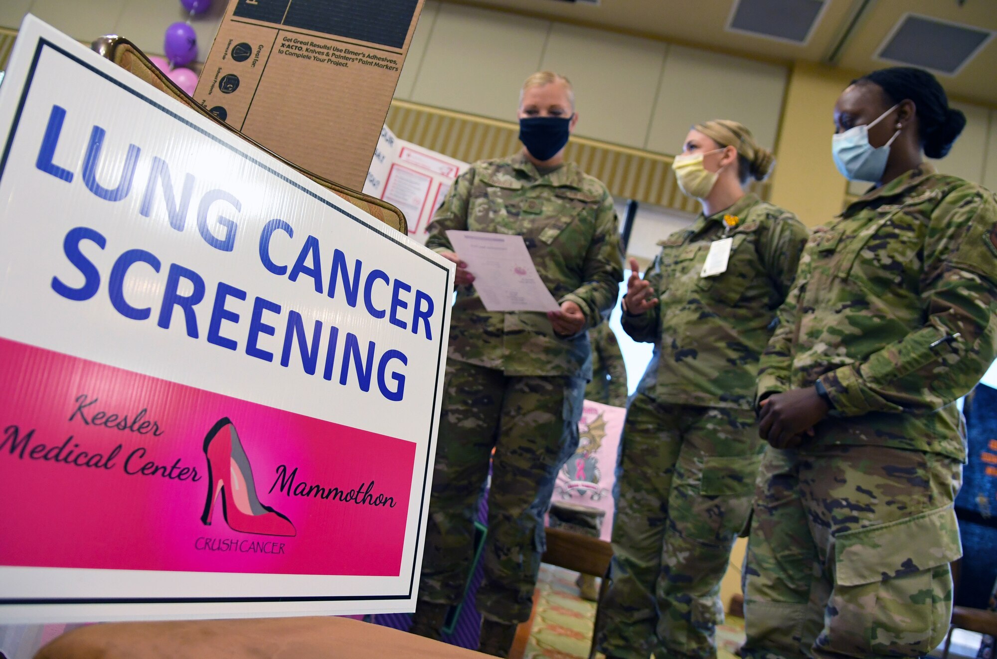 U.S. Air Force Senior Airman Ashley Rodriguez and Staff Sgt. Malika Roberts, 81st Healthcare Operations Squadron respiratory therapists, provides lung cancer screening information to Chief Master Sgt. Sarah Esparza, 81st Training Wing command chief master sergeant, during the 10th Annual 81st Medical Group Health Expo inside the Bay Breeze Event Center at Keesler Air Force Base, Mississippi, October 1, 2021. The 81st MDG hosted the walk-in event which included information booths and scheduling appointments for multiple types of cancer and chronic diseases in honor of Breast Cancer Awareness Month. (U.S. Air Force photo by Kemberly Groue)