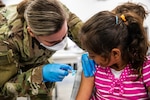 U.S. Army Capt. Breanna Alis, attached to 10th Field Hospital, Task Force McCoy, vaccinates an Afghan evacuee during a mass vaccination campaign at Fort McCoy, Wisconsin, Sept. 16, 2021, as part of Operation Allies Welcome. The Department of Defense, through U.S. Northern Command, and in support of the Department of Homeland Security, is providing transportation, temporary housing, medical screening, and general support for at least 50,000 Afghan evacuees at suitable facilities, in permanent or temporary structures, as quickly as possible. This initiative provides Afghan personnel essential support at secure locations outside Afghanistan. (U.S. Army photo by Spc. Rhianna Ballenger, 55th Signal Company)