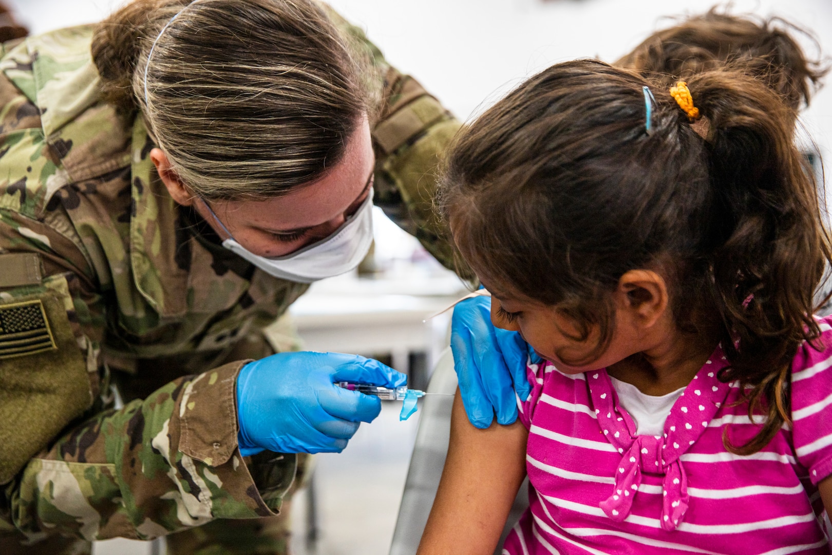 U.S. Army Capt. Breanna Alis, attached to 10th Field Hospital, Task Force McCoy, vaccinates an Afghan evacuee during a mass vaccination campaign at Fort McCoy, Wisconsin, Sept. 16, 2021, as part of Operation Allies Welcome. The Department of Defense, through U.S. Northern Command, and in support of the Department of Homeland Security, is providing transportation, temporary housing, medical screening, and general support for at least 50,000 Afghan evacuees at suitable facilities, in permanent or temporary structures, as quickly as possible. This initiative provides Afghan personnel essential support at secure locations outside Afghanistan. (U.S. Army photo by Spc. Rhianna Ballenger, 55th Signal Company)