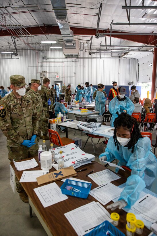 U.S. Army Soldiers attached to Task Force McCoy organize vaccines for families during a mass vaccination campaign at Fort McCoy, Wisconsin, Sept. 16, 2021, as part of Operation Allies Welcome. The Department of Defense, through U.S. Northern Command, and in support of the Department of Homeland Security, is providing transportation, temporary housing, medical screening, and general support for at least 50,000 Afghan evacuees at suitable facilities, in permanent or temporary structures, as quickly as possible. This initiative provides Afghan personnel essential support at secure locations outside Afghanistan. (U.S. Army photo by Spc. Rhianna Ballenger, 55th Signal Company)