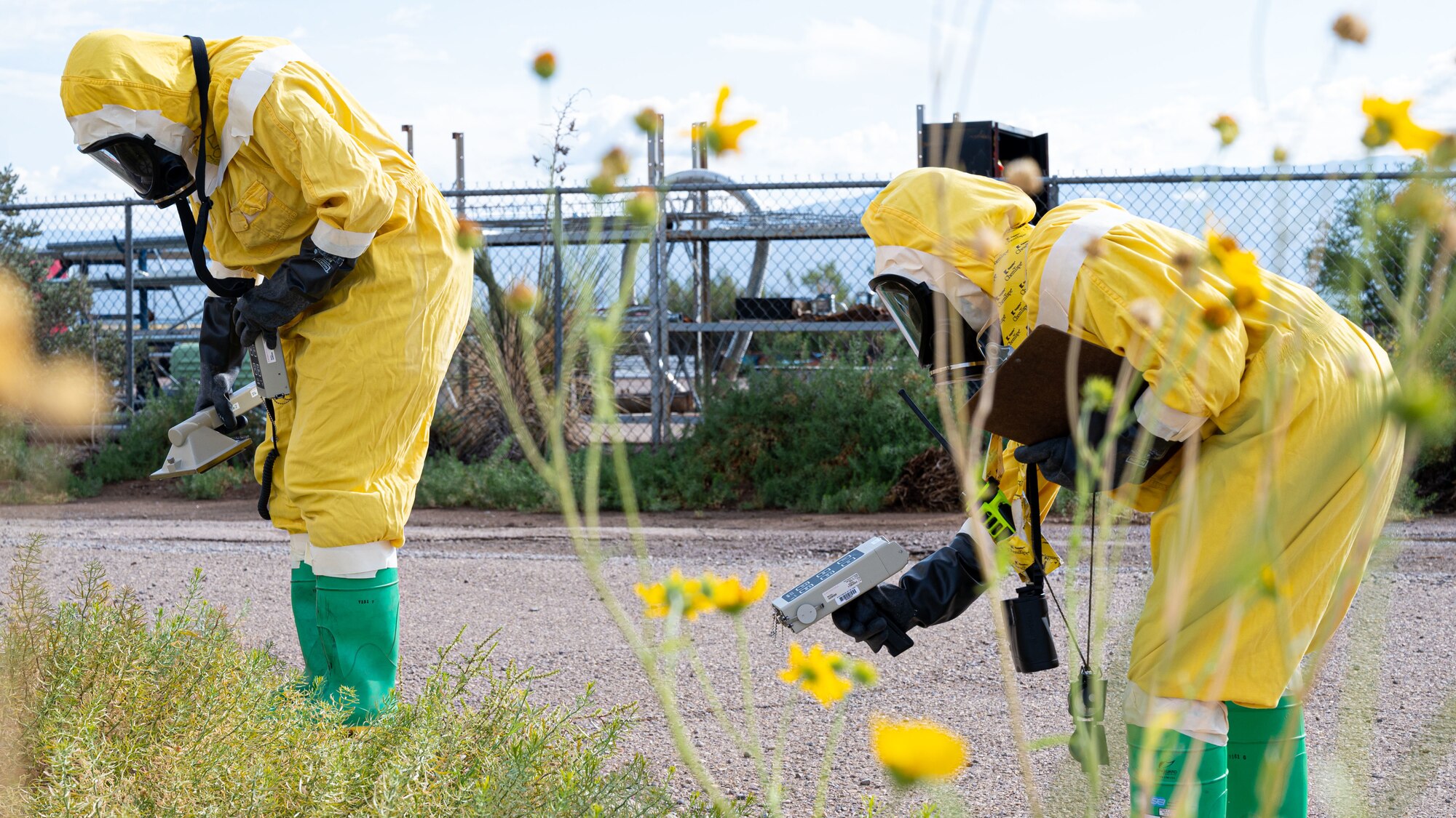 (From left to right) Tech. Sgt. Lisa Sandahl, 49th Civil Engineer Squadron emergency management noncommissioned officer in charge and Airman 1st Class Erika Vega, 49th CES emergency management apprentice, detect for possible beta, gamma and alpha radiation during a radiological survey exercise Oct. 1, 2021 on Holloman Air Force Base, New Mexico. Survey teams typically consist of two to three people, and radiation is detected using ADM-300 radiation survey meters. (U.S. Air Force photo by Tech. Sgt. BreeAnn Sachs)