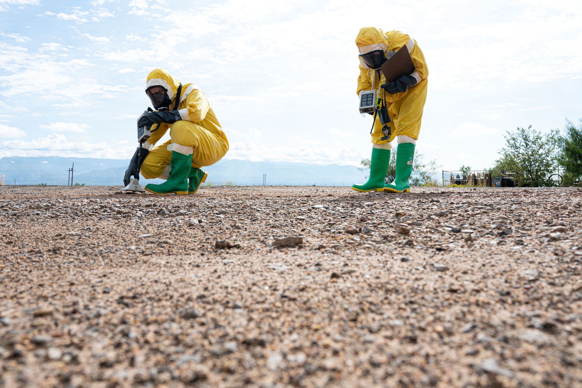 (From left to right) Tech. Sgt. Lisa Sandahl, 49th Civil Engineer Squadron emergency management noncommissioned officer in charge and Airman 1st Class Erika Vega, 49th CES emergency management apprentice, detect for possible beta, gamma and alpha radiation with ADM-300 radiation survey meters during a radiological survey exercise Oct. 1, 2021 on Holloman Air Force Base, New Mexico. Sandahl surveyed for beta and gamma radiation as the front survey team member, and Vega surveyed for alpha radiation. (U.S. Air Force photo by Tech. Sgt. BreeAnn Sachs)