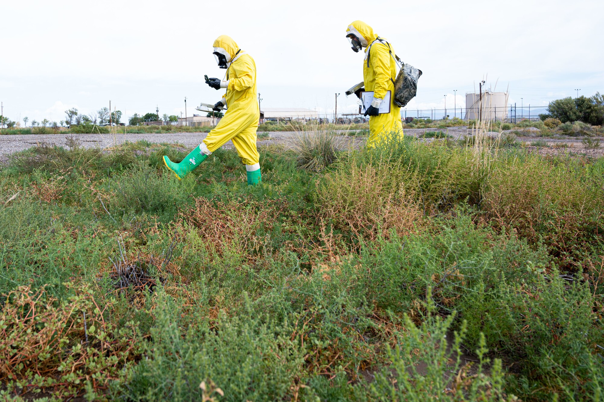 (From left to right) Airman 1st Class Shayne Watts, 49th Civil Engineer Squadron emergency management journeyman and Staff Sgt. Christopher Greeno, 49th CES emergency management craftsman, search for a possible radiation source during a radiological survey exercise Oct. 1, 2021 on Holloman Air Force Base, New Mexico. Watts surveyed for beta and gamma radiation as the front survey team member, and Greeno surveyed for alpha radiation. (U.S. Air Force photo by Tech. Sgt. BreeAnn Sachs)