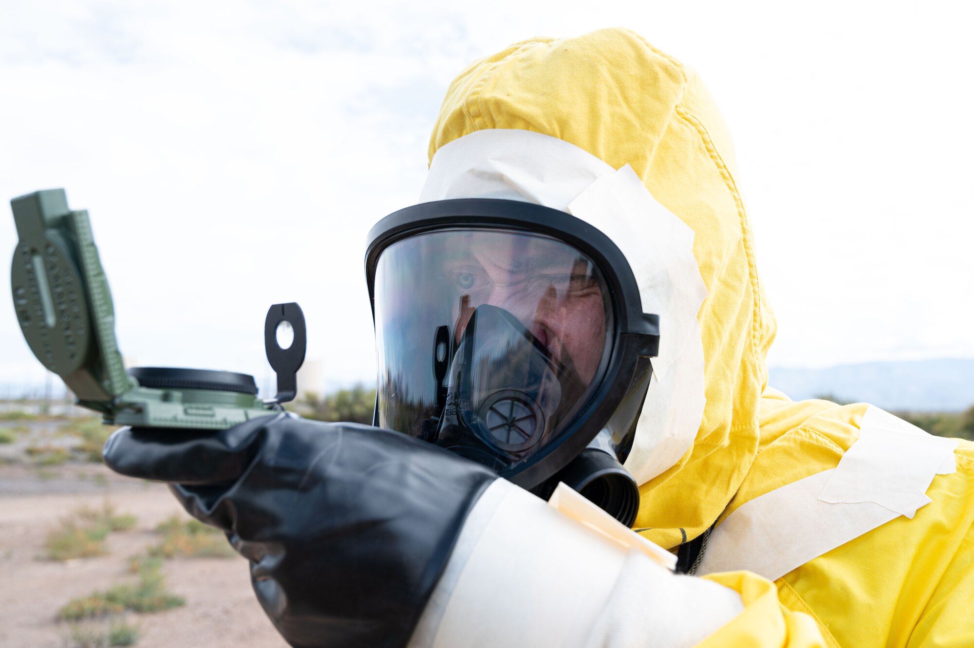 Airman 1st Class Shayne Watts, 49th Civil Engineer Squadron emergency management journeyman, reads a compass while preforming an eight-leg survey during a radiological survey exercise Oct. 1, 2021 on Holloman Air Force Base, New Mexico. A compass is used during the eight-leg survey to ensure survey teams are walking in a straight path. (U.S. Air Force photo by Tech. Sgt. BreeAnn Sachs)