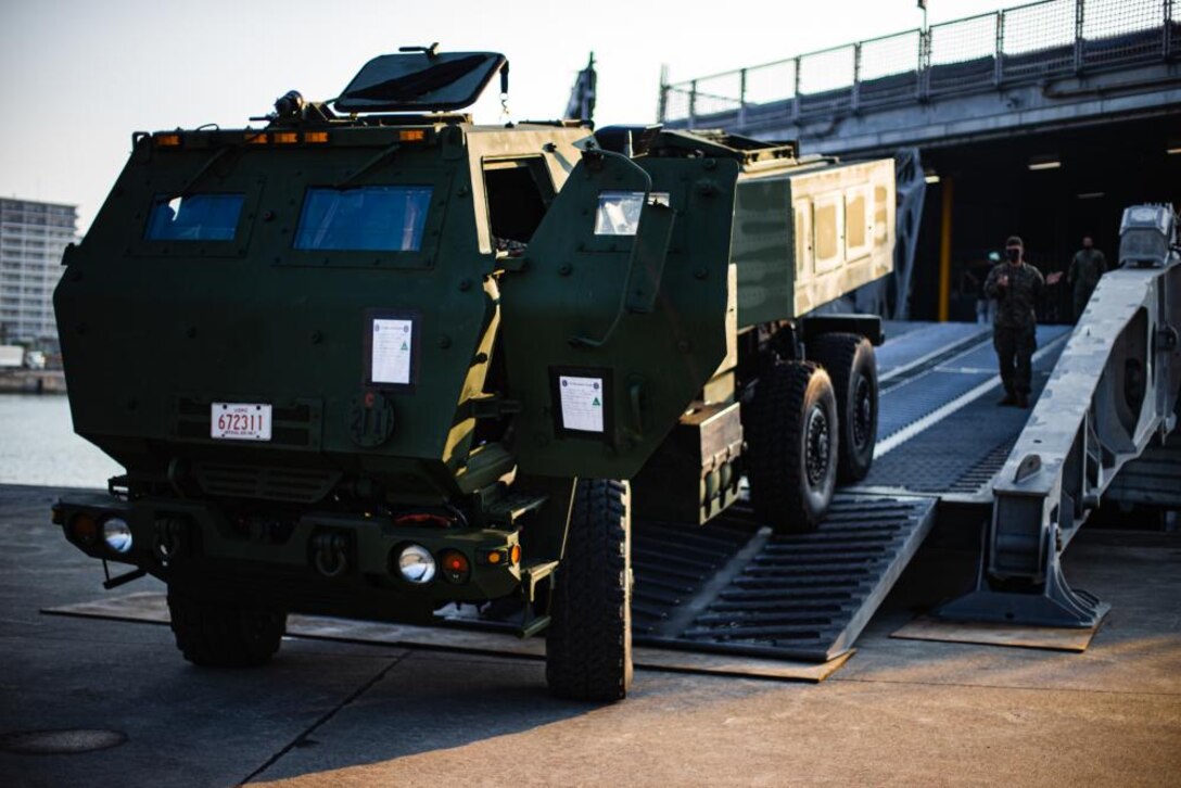 U.S. Marines with 3d Battalion, 12th Marines load a High Mobility Artillery Rocket System onto the USNS Brunswick during Exercise Noble Jaguar 2021 at Naha Port, Okinawa, Japan, Sept. 28, 2021. The Marine Corps and Navy leveraged integrated command and control and joint sensors to expand battlefield awareness, share targeting data, and conduct long-range precision strikes in support of sea control and sea denial in contested maritime environments. III Marine Expeditionary Force executed these actions as a part of an integrated operation with 7th Fleet to maintain readiness and demonstrate U.S. resolve to preserve regional security. (U.S. Marine Corps photo by Lance Cpl. Ujian Gosun)