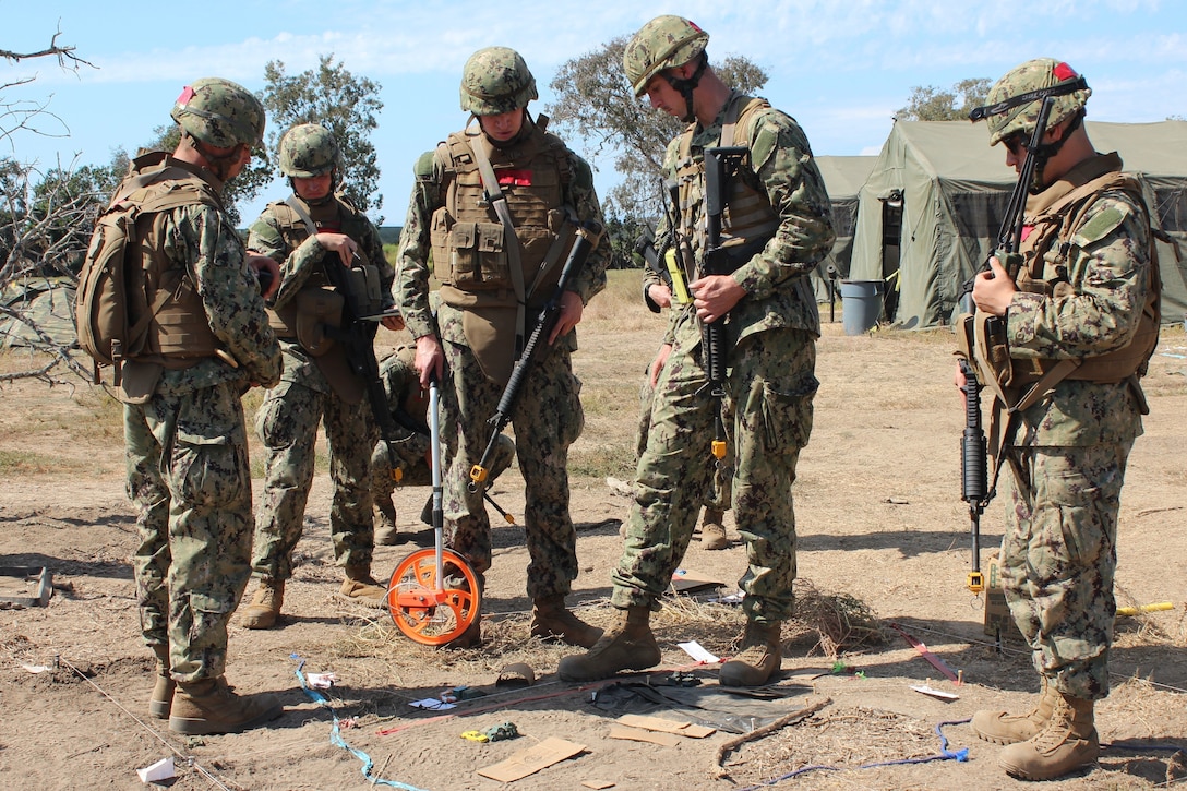 Civil Engineer Corps (CEC) Officers School Basic Qualification Course students use a terrain model