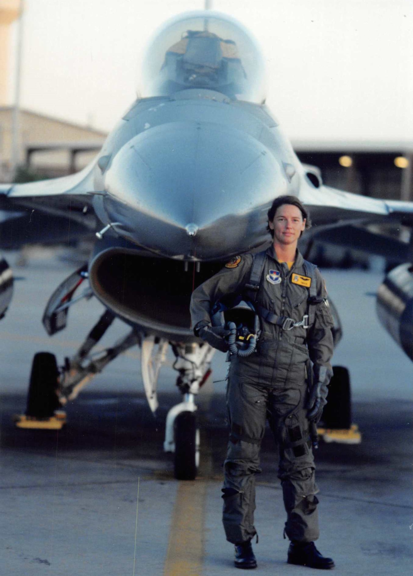 Then-Capt. Sherrie McCandless, an Air Force pilot, poses in front of an F-16 Fighting Falcon in the mid-1990s.