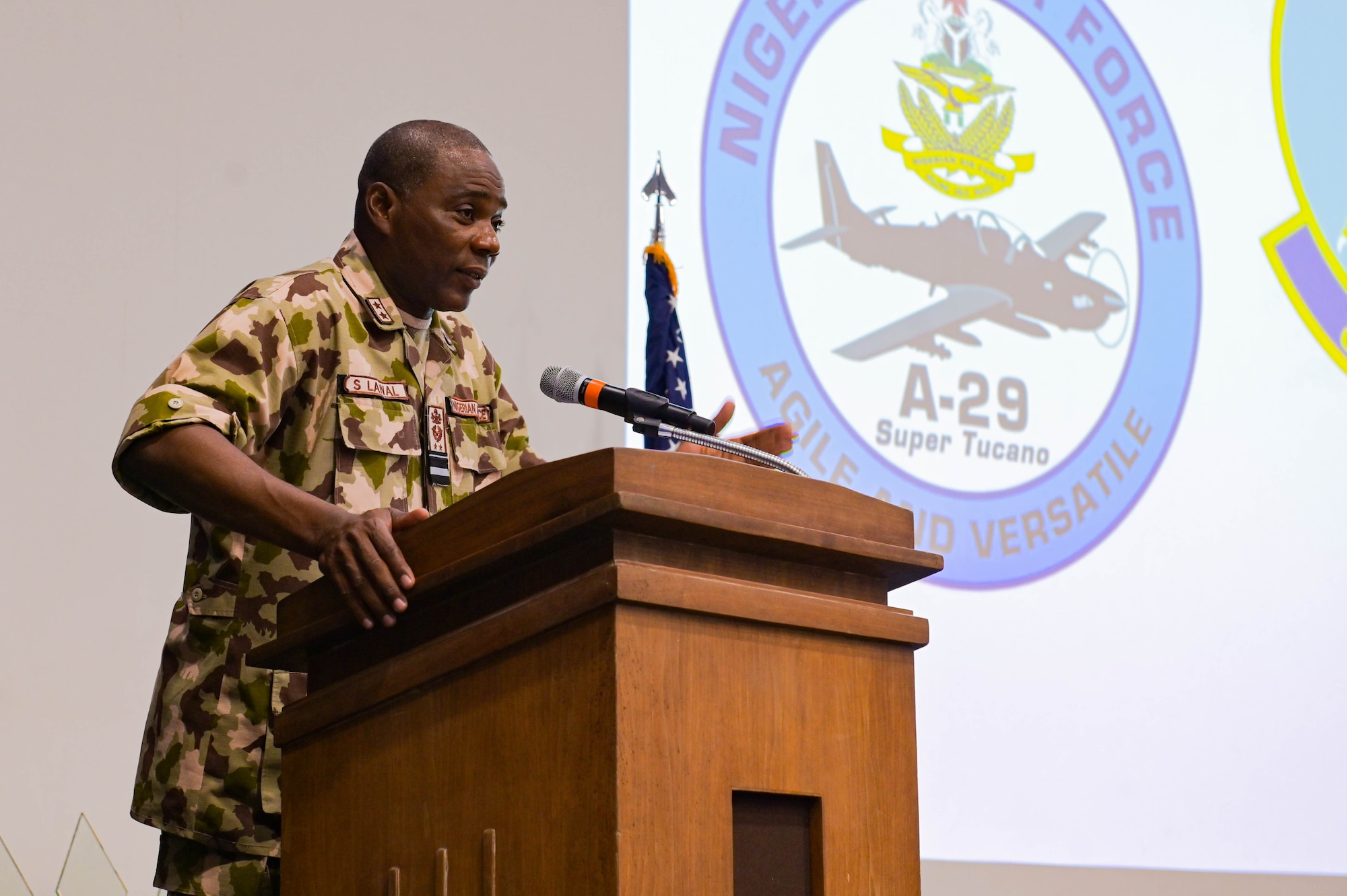 Nigerian Air Force Air Vice Marshal Sule Lawal, Nigerian A-29 program lead foreign liaison officer, gives a speech during the NAF A-29 pilot graduation ceremony at Moody Air Force Base, Georgia, Sept. 2, 2021. Each pilot has accomplished more than 70 hours of formal academics, 65 hours of simulators, and between 50-100 hours of flying, depending on their specific track. (U.S. Air Force photo by Senior Airman Rebeckah Medeiros)