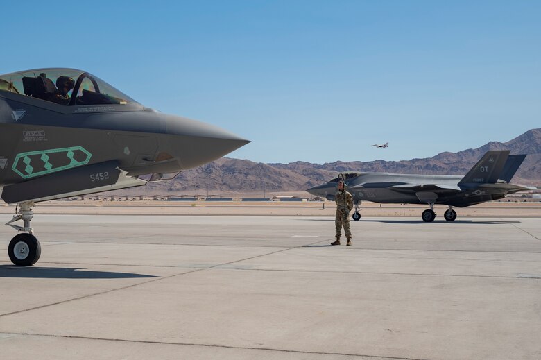 Airman 1st Class Javier Farcia-Bustos waits for an F-35A pilot assigned to the 442nd Test and Evaluation Squadron to complete pre-flight checks on the flight line at Nellis Air Force Base, Nevada, Sept. 21, 2021. The 442nd and 59th Test and Evaluation Squadrons led Air Combat Command’s portion of a nuclear design certification test with maintenance support from the 57th Aircraft Maintenance Squadron and Bolt Aircraft Maintenance Unit. (U.S. Air Force photo by Airman 1st Class Zachary Rufus)